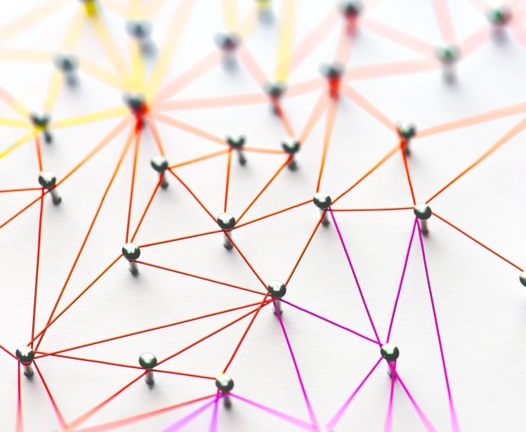 Linking entities. Networking, social media, SNS, internet communication abstract. Small network connected to a larger network. Web of red, orange and yellow wires on white background.