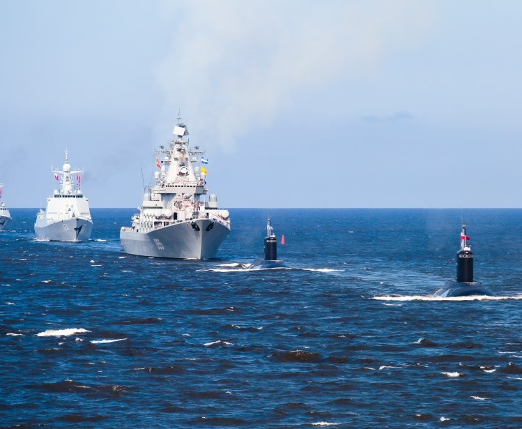 A line of modern russian military naval battleships warships in the row, northern fleet and baltic sea fleet in the open sea
