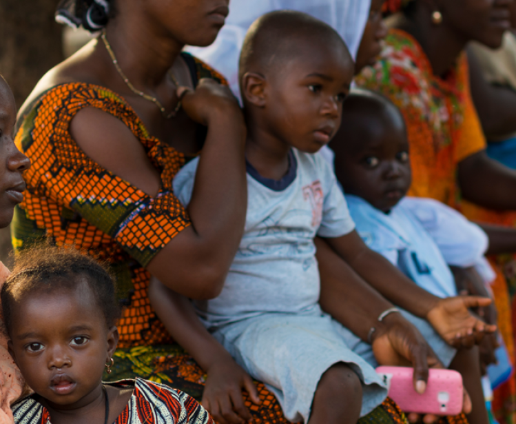  Portrait of a young mother and her baby daughter during a community meeting, at the Bissaque neighborhood in the city of Bissau, Guinea Bissau.