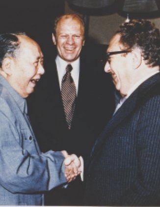 President Ford and daughter Susan watch as Secretary of State Henry Kissinger shakes hands with Mao Tse-Tung; Chairman of Chinese Communist Party, during a visit to the Chairman’s residence.  
