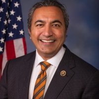 Congressman Ami Bera standing in front of an American flag