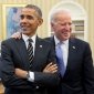 Joe Biden stands with his arm around President Obama in the Oval Office.