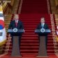 President Donald Trump and President Moon Jae-In stand at podiums during a press conference.