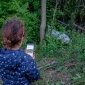 Child doing Earth Challenge in woods