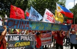 Demonstrators display a part of a fishing boat with anti-China protest signs during a rally by different activist groups over the South China Sea disputes, outside the Chinese Consulate in Makati City, Metro Manila, Philippines