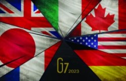 A picture of the seven flags of the G7 countries on fracturing glass shards.