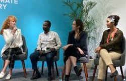 Christianne Zakour, Hassan Mowlid Yasin, and another young leader speak with Elsa Barron at a panel during COP27.