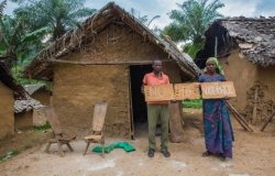 A husband and wife in the Democratic Republic of Congo hold signs up in opposition to sexual and gender-based violence