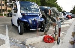 U.S. Army Spc. Dean Kalogris charges electric car at Fort Bliss, Texas.