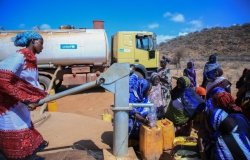 A group of women pump water in a drought-hit area of Ethiopia.