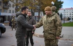 President Zelensky shaking hands with member of Ukrainian Military 