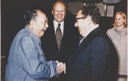 President Ford and daughter Susan watch as Secretary of State Henry Kissinger shakes hands with Mao Tse-Tung; Chairman of Chinese Communist Party, during a visit to the Chairman’s residence.