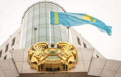  Flag of Kazakhstan and coat of arms over the main entrance to the Kazakhstan Senate building in downtown Astana