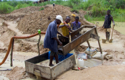A group of men washing the soil and working the land in search of diamonds
