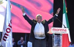 AMLO with his hands up at a Morena rally