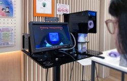 Self-service temperature taking screening station at local town community centre.