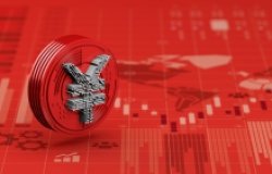 A red coin with a silver yuan sits on a red economic chart