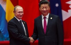A picture of Xi Jinping and Vladimir Putin shaking hands.