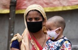 A woman with her child arrived at a bus stop to catch a bus