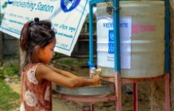 Child in a Cox’s Bazar refugee camp washes their hands in a newly installed wash station as a precaution for Covid-19