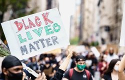 Protests in New York. People with protesting posters marching protest over George Floyd death. Black lives matter movement in New York. 