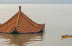 Man paddling on flooded Yangtze river in Wuhan, China.