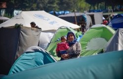 Woman with a baby in transit refugee/migrant camp at the Greek-North Macedonian border.