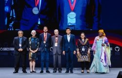 seven individuals standing on stage at ICFP 2022