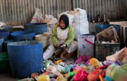 a woman sorting plastic waste