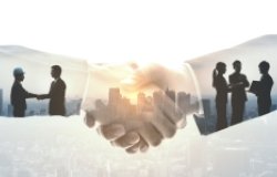 Shaking hands over background of buildings