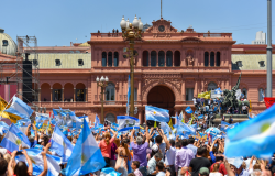 Supporters wave argentine flags outside la casa rosada