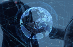 Two people shaking hands behind an image of the world