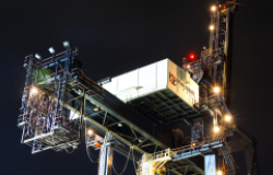 Dutch Harbor, Unalaska, Alaska, USA - August 14th, 2017: Night view of a port crane for shipping containers operated by Horizon Lines located at the port of Unalaska, Alaska