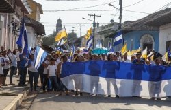 Granada, Nicaragua - May 29, 2018: peaceful protests in Granada Nicaragua for reform of INSS, people flying the Nicaraguan flag