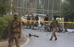 Security personnel arrive at the site of a suicide bomber attack in Peshawar, the capital of Khyber Pakhtunkhwa, in Pakistan, Tuesday, July 18, 2023. A suicide bomber targeted a truck carrying security forces in northwestern Pakistan on Tuesday, wounding a number of people, police said amid increasing violence in the region. 