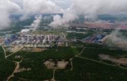 Coal fire electric power plant generates electricity to send to power transmission towers