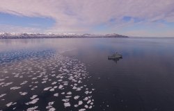 Photo of a ship sailing near ice
