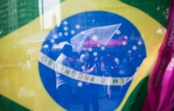 Brazilian Flag with Protest behind