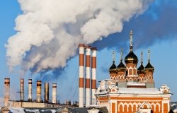 Smoking chimneys over blue sky