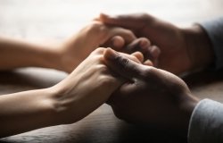 A couple holding hands over a table,=