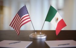 USA and Mexican flags on table