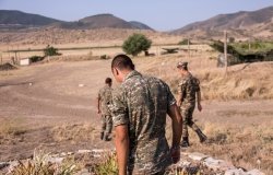 Nagorno-Karabakh, Republic of Artsakh - 08/03/2019 - Three soldiers of the Artsakh Defense Army walking on dirt road in their off time