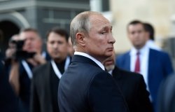 Vladimir Putin in profile looks over his shoulder