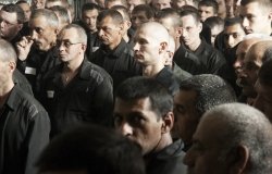 Large group of men in prisoner clothing 