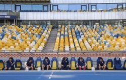 Desna Chernihiv players sit on a bench keeping a safe quarantine distance during the Ukrainian Premiere League game against Shakhtar at NSC Olympiyskyi stadium in Kyiv