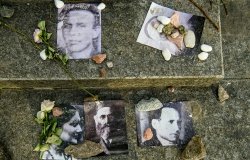Portraits of killed Jews near Menorah monument in Memory of Jews Victims at the Babyn Yar National Historical Memorial. October 2020 Kyiv, Ukraine.