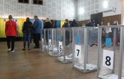 ODESSA, UKRAINE -25.10.2020 - Elections in Ukraine. Electoral platform for elections of local councilors during the COVID-19 coronavirus pandemic. People wearing masks and gloves with voting ballots