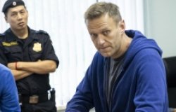 Russian opposition leader Alexei Navalny watched by a police officer, December 2020