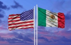 U.S. and Mexican flags at sunset