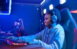 Portrait Streamer African young woman professional gamer playing online games computer, neon color.